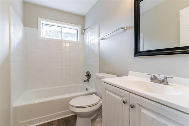 full bathroom featuring vanity, toilet, wood-type flooring, and tiled shower / bath combo