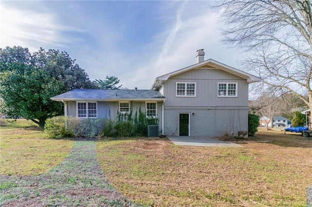 back of house featuring a lawn, central AC unit, and a patio