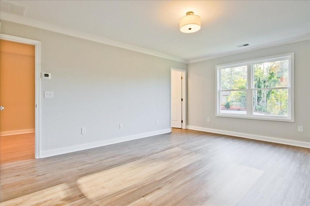 unfurnished room with ornamental molding and light hardwood / wood-style flooring