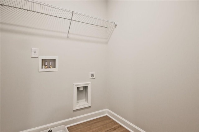 clothes washing area featuring washer hookup, electric dryer hookup, and hardwood / wood-style floors