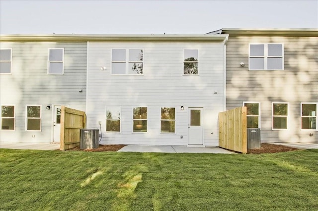 back of property with a yard and a patio