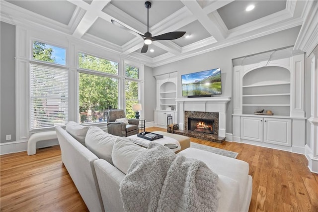 2517 Stone Manor Dr, Buford, GA 30519 - living area featuring built in shelves, ceiling fan, a fireplace, healthy amount of natural light, and coffered ceiling
