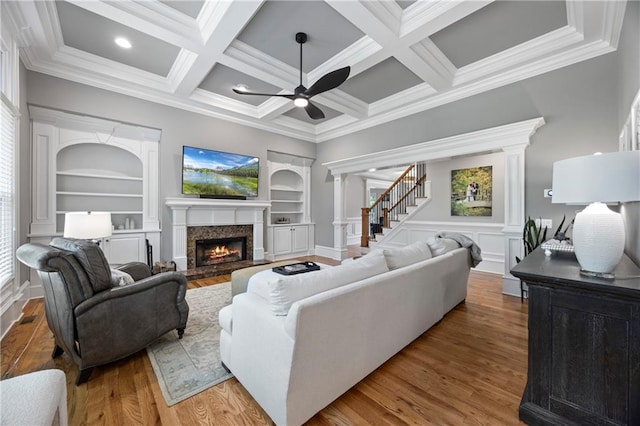 2517 Stone Manor Dr, Buford, GA 30519 - living area with ceiling fan, a lit fireplace, built in features, crown molding, and wood finished floors