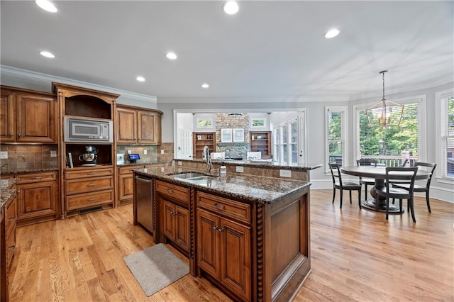 2517 Stone Manor Dr, Buford, GA 30519 - kitchen featuring a sink, stainless steel appliances, brown cabinets, decorative backsplash, and ornamental molding