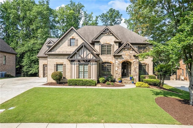 2517 Stone Manor Dr, Buford, GA 30519 - view of front of home featuring a front yard, roof with shingles, brick siding, and stone siding