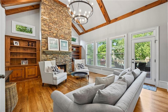 2517 Stone Manor Dr, Buford, GA 30519 - living area with high vaulted ceiling, beamed ceiling, a chandelier, wood finished floors, and a fireplace