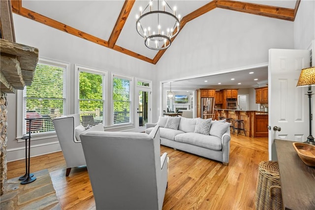 2517 Stone Manor Dr, Buford, GA 30519 - living area with high vaulted ceiling, light wood finished floors, healthy amount of natural light, a chandelier, and beam ceiling