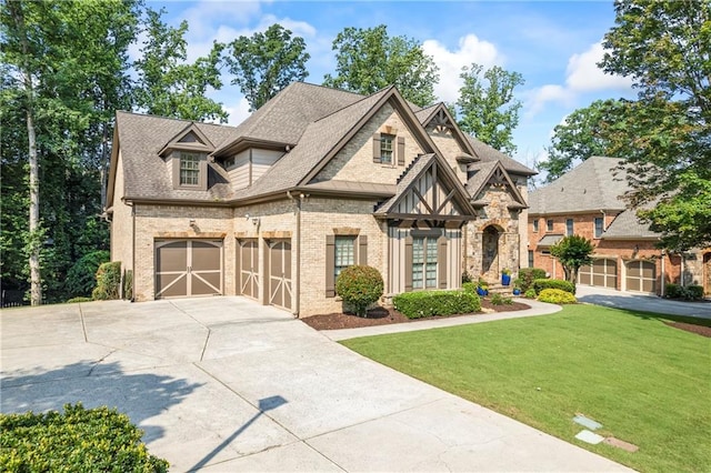 2517 Stone Manor Dr, Buford, GA 30519 - view of front of property with concrete driveway, a front yard, an attached garage, brick siding, and a shingled roof