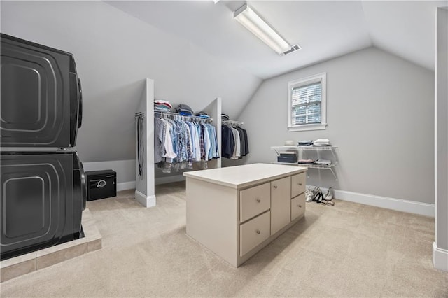 2517 Stone Manor Dr, Buford, GA 30519 - walk in closet featuring estacked washer and dryer, light carpet, and lofted ceiling