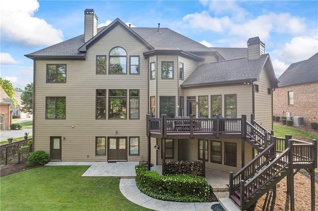 2517 Stone Manor Dr, Buford, GA 30519 - back of house featuring a chimney, a patio, a wooden deck, and central AC