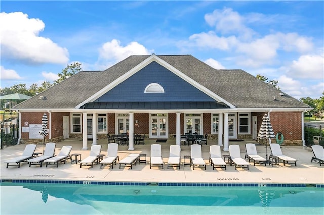 2517 Stone Manor Dr, Buford, GA 30519 - rear view of house featuring french doors, brick siding, and a community pool