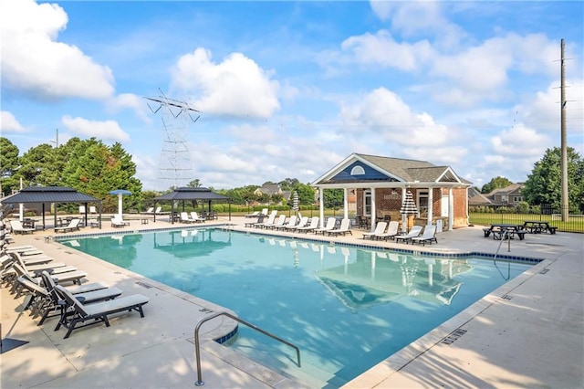 2517 Stone Manor Dr, Buford, GA 30519 - community pool featuring a gazebo, a patio area, and an outbuilding