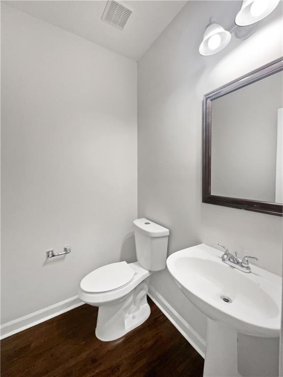 63 Couch Rd, Senoia, GA 30276 - half bath with baseboards, wood finished floors, and toilet