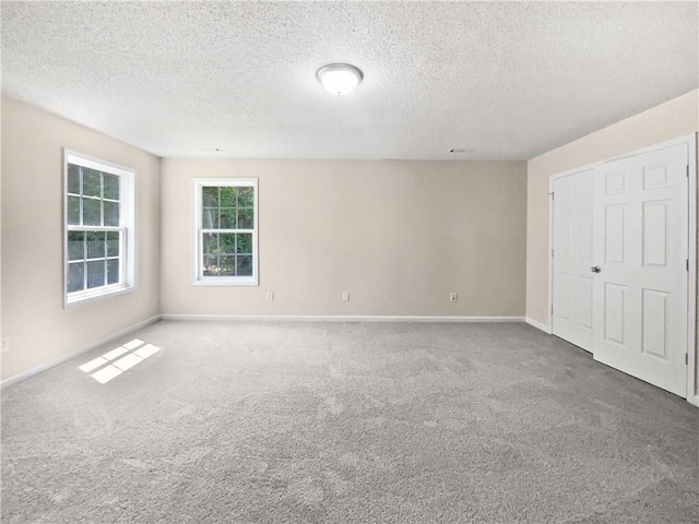 63 Couch Rd, Senoia, GA 30276 - unfurnished bedroom with a textured ceiling, baseboards, and carpet flooring
