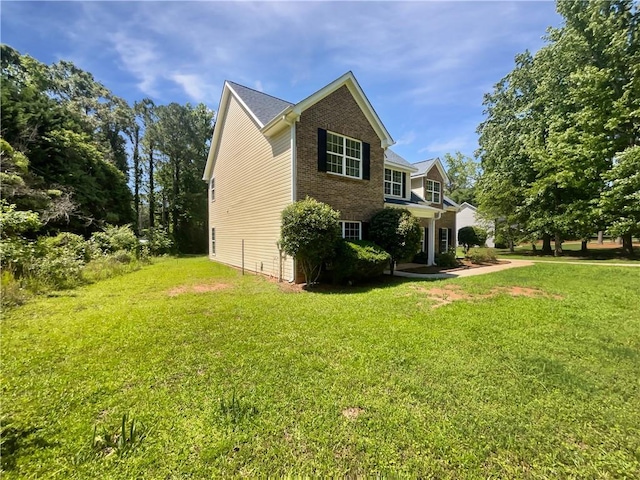 63 Couch Rd, Senoia, GA 30276 - view of home's exterior featuring brick siding and a yard