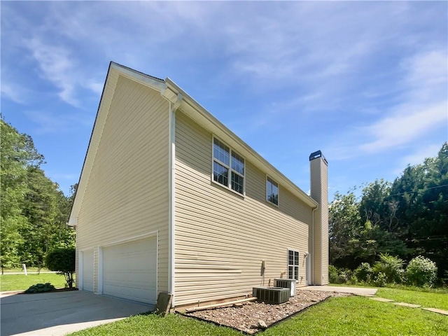 63 Couch Rd, Senoia, GA 30276 - view of home's exterior with a garage, a chimney, a lawn, and concrete driveway
