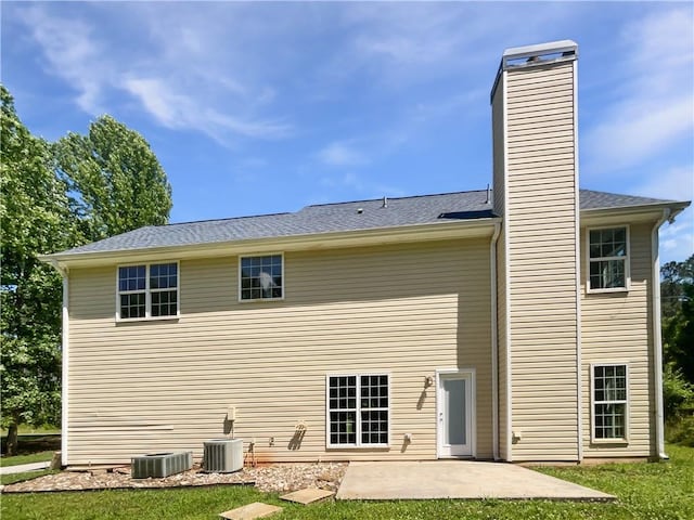 63 Couch Rd, Senoia, GA 30276 - rear view of property featuring a chimney, a patio, cooling unit, and a lawn