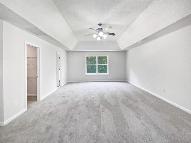 63 Couch Rd, Senoia, GA 30276 - unfurnished bedroom featuring a raised ceiling, carpet flooring, a spacious closet, baseboards, and a textured ceiling