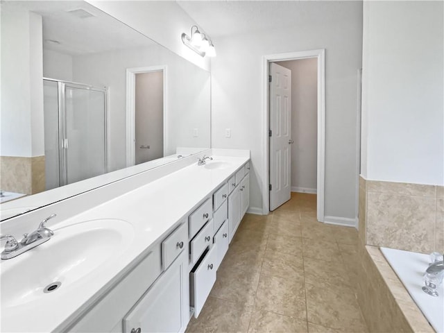 63 Couch Rd, Senoia, GA 30276 - full bath featuring double vanity, a stall shower, a garden tub, and tile patterned flooring