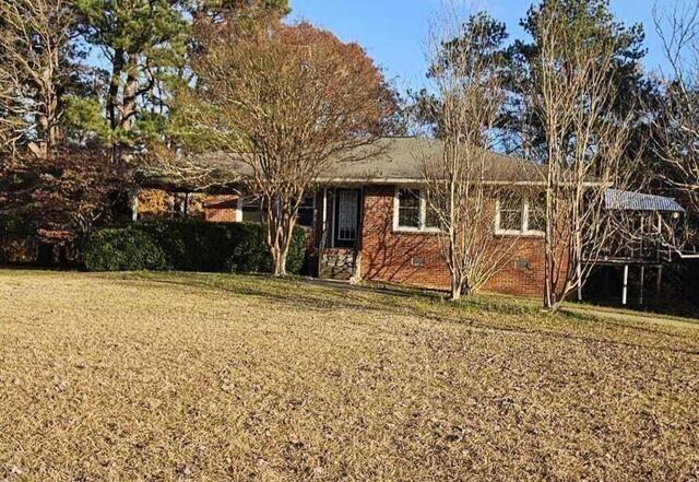 front facade featuring a garage and a front yard