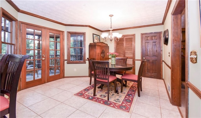 dining room featuring french doors, crown molding, and light tile patterned floors