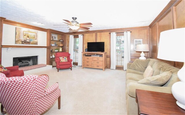 living room with crown molding, light colored carpet, and ceiling fan