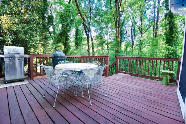 wooden terrace featuring a grill