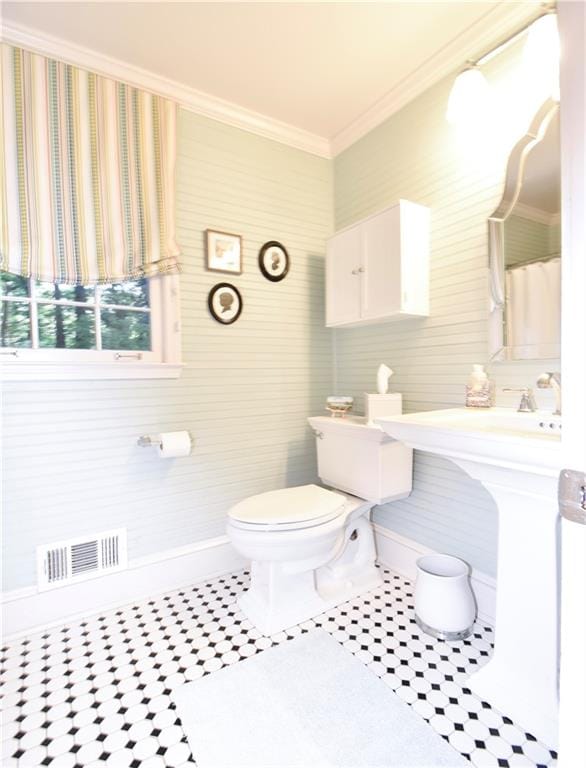 bathroom featuring ornamental molding, toilet, and tile patterned flooring