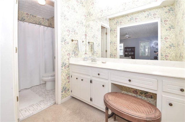 bathroom with vanity, a shower with shower curtain, toilet, and ceiling fan