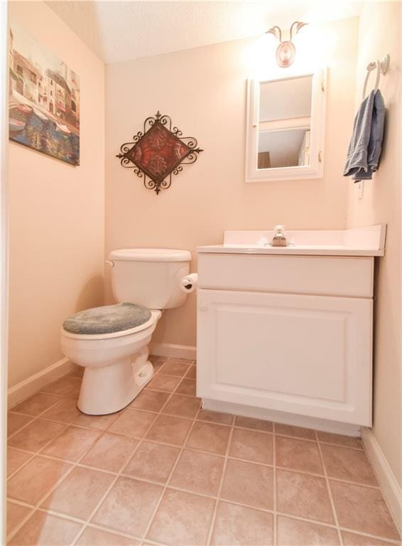 bathroom featuring vanity, toilet, and tile patterned floors