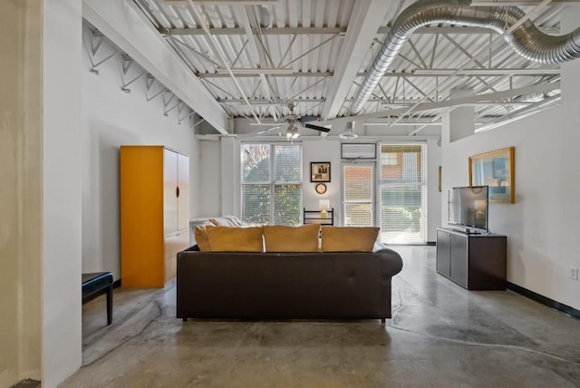 living room featuring plenty of natural light and concrete floors