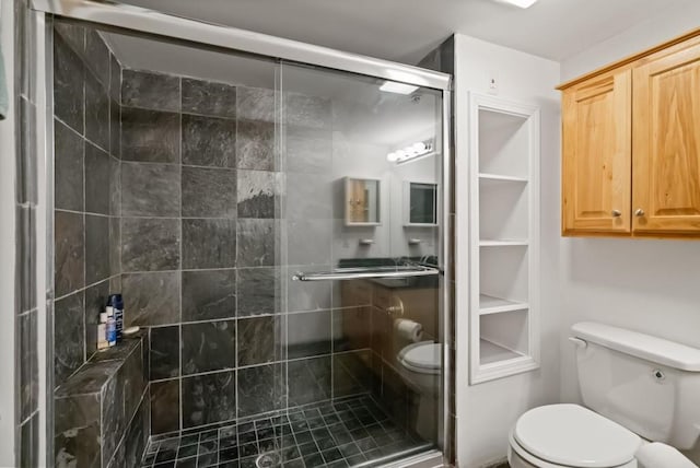 bathroom with toilet and a shower with shower door