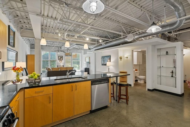 kitchen with stainless steel appliances, a kitchen bar, and sink