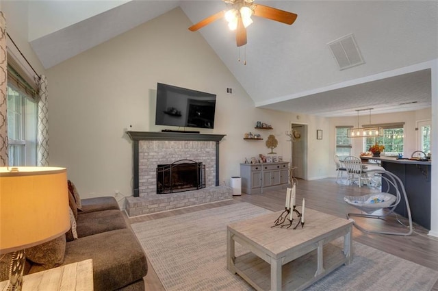 260 Brannon Dr, Hoschton, GA 30548 - living area with a ceiling fan, high vaulted ceiling, a brick fireplace, wood finished floors, and baseboards