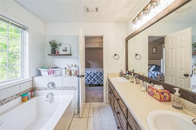 260 Brannon Dr, Hoschton, GA 30548 - full bathroom featuring ensuite bath, healthy amount of natural light, tile patterned flooring, double vanity, and a textured ceiling