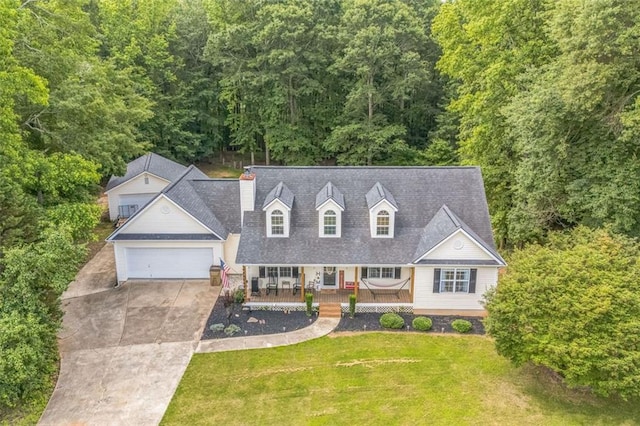 260 Brannon Dr, Hoschton, GA 30548 - cape cod home featuring a porch, concrete driveway, a front yard, a chimney, and a forest view