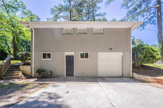 2755 Rockcliff Rd SE, Atlanta, GA 30316 - back of property with an attached garage, concrete driveway, and brick siding