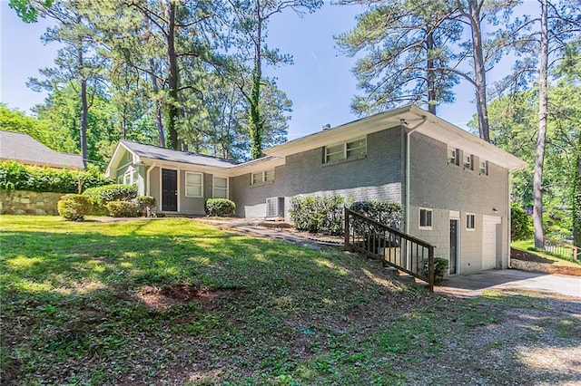 2755 Rockcliff Rd SE, Atlanta, GA 30316 - rear view of house featuring driveway, brick siding, and a lawn