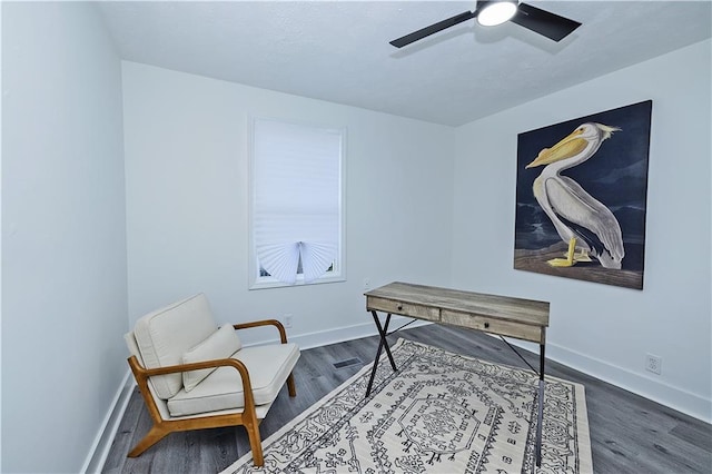 office area featuring ceiling fan, baseboards, and wood finished floors