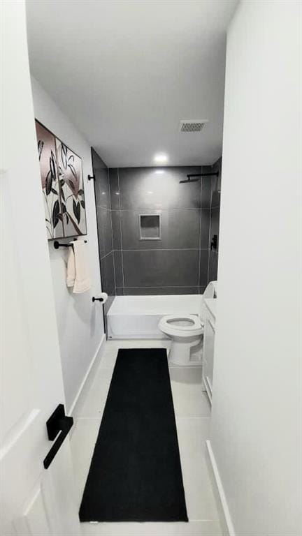 full bathroom featuring toilet, visible vents, baseboards, tub / shower combination, and tile patterned floors