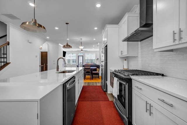 4565 Sims Park Ovlk, Suwanee, GA 30024 - kitchen with stainless steel appliances, wall chimney exhaust hood, a sink, light countertops, and recessed lighting