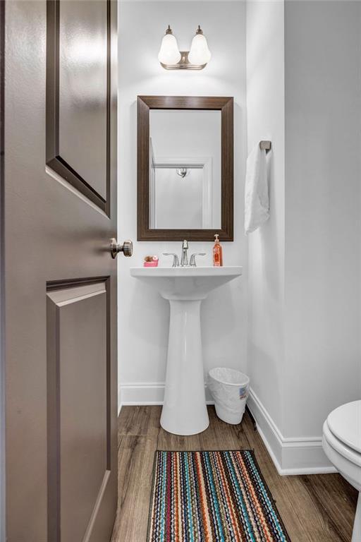 4565 Sims Park Ovlk, Suwanee, GA 30024 - bathroom featuring wood finished floors, baseboards, and toilet