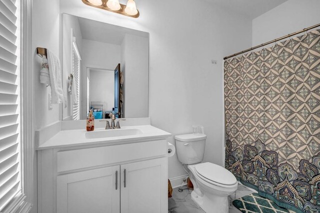 4565 Sims Park Ovlk, Suwanee, GA 30024 - bathroom with toilet, vanity, marble look tile flooring, and curtained shower