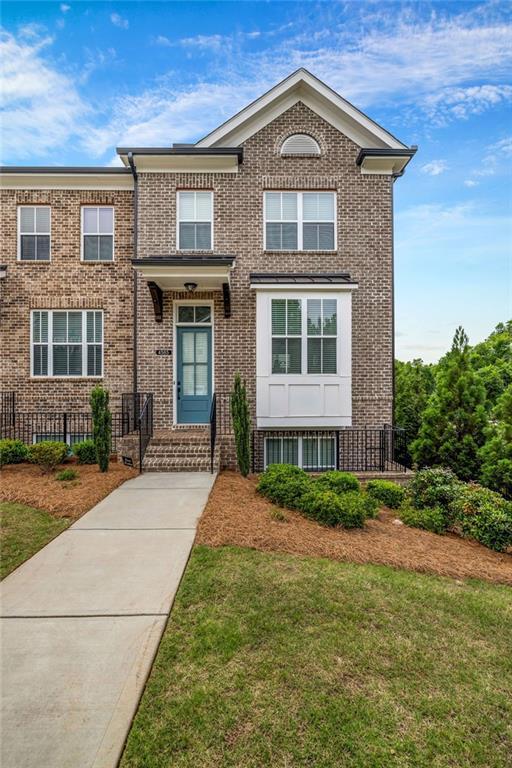 4565 Sims Park Ovlk, Suwanee, GA 30024 - view of front of house with brick siding and a front yard