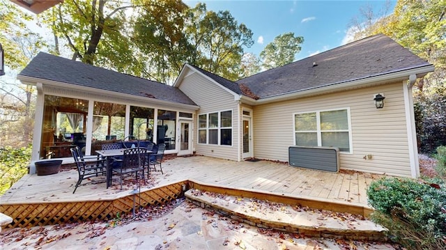 back of property featuring a shingled roof, outdoor dining space, and a deck