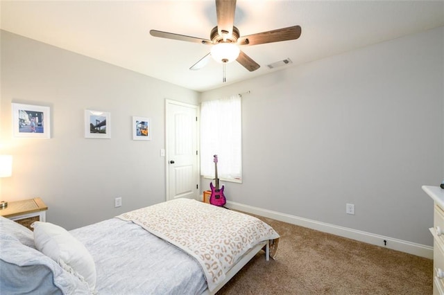 carpeted bedroom with ceiling fan, visible vents, and baseboards