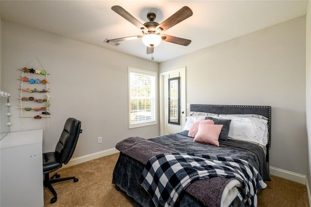 carpeted bedroom featuring ceiling fan, visible vents, and baseboards