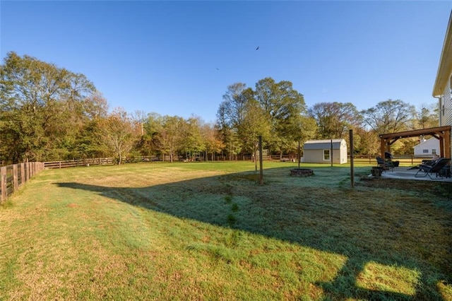 view of yard with an outbuilding, a patio area, and a fenced backyard