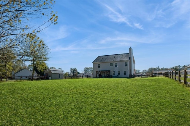 exterior space featuring a fenced backyard and an outdoor structure