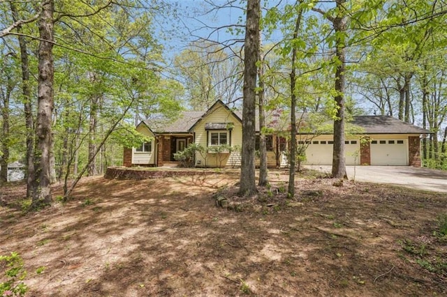 ranch-style home featuring concrete driveway and a garage